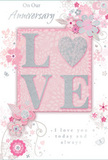 This romantic anniversary card offers a quiet celebration of enduring love, blending soft pastel pinks with cool silvery greys to create an intimate, treasured mood. At its heart, the word "LOVE" is featured in softly raised glitter, each letter defined yet gentle to the touch, with the "O" replaced by a shimmering, silver-textured heart that serves as the focal point. The central motif sits against a blush background that seems to glow, much like the warm light falling across flowers arranged for a special delivery somewhere off Manor Road in Wallington. Around this, delicate blossoms in blush and mauve float across the card in an almost watercolour softness, their outlines fine and fluid, suggesting both tenderness and attentive care. Petals, curling swirls, and tiny, near-silhouetted butterflies add a feeling of movement, reminiscent of an English spring garden just after rain. Subtle highlights of silver give the sense of cool, early-evening light glinting off polished glass vases. The accompanying text-phrases like "On Our Anniversary" and "I love you today and always"-appears in an understated, graceful script that feels personal and heartfelt, as if handwritten. Every element of the composition, from colour to spacing, mirrors the artful balance of an anniversary bouquet thoughtfully composed for delivery in and around Beddington and central Wallington. The card carries a whisper-soft sense of occasion, offering a keepsake that honours shared years with quiet, profound warmth.